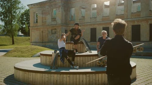 Stylish Cool Teenagers Chilling on the Benches in the Park. Two Girls and Two Boys Resting with The