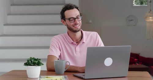 Man Using Laptop at Home During Video Call