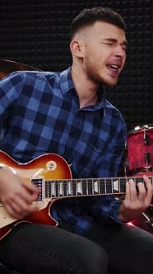 Professional guitarist playing on guitar at rehearsal studio. Vertical video