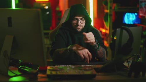 Hacker Writing Code Cracking Computer Man Programmer in Hoodie Cracks System Using Computer in Dark