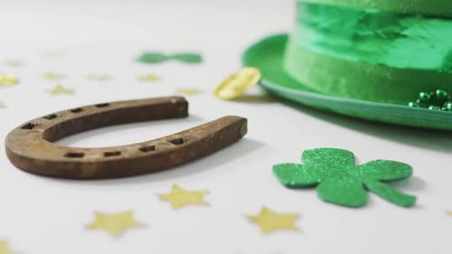 Shamrocks and stars with green hat with horseshoe with copy space on white background