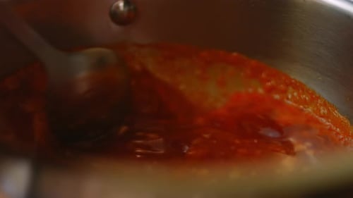 Red Sauce Simmering in Stainless Steel Pot