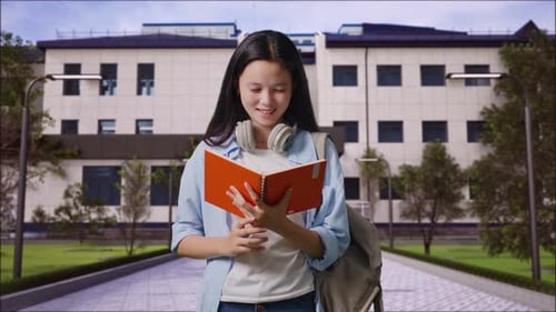Girl Student Reading Book And Screaming Goal Celebrating Succeed Learning in Front of a School