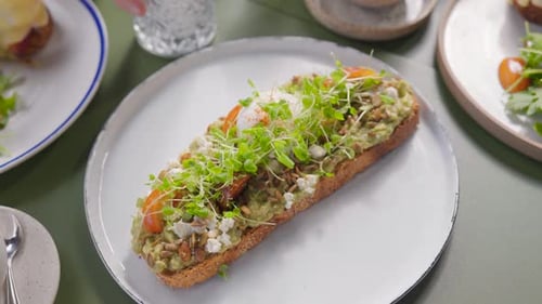 Avocado Toast with Egg Topped With Sprouts and Seeds
