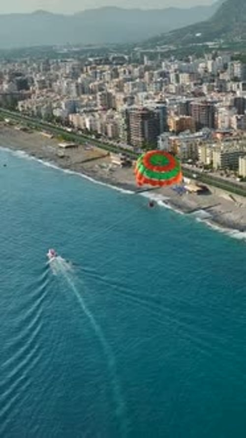Vertical Video Adrenaline Rush Parasailing From a Sport Boat