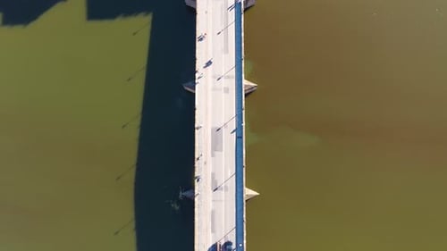 Top down view rising high above roofs, roads and city on a sunny day in Florence in Italy in 4k.