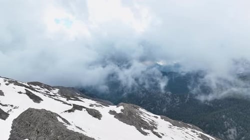 Snowy Mountain Peaks Above the Clouds