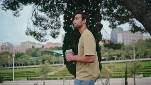 Casual Man Walking Alley Garden Drinking Coffee Latin Guy Strolling Green Park