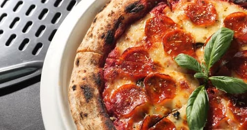 Close Up of Pepperoni Pizza with Fresh Basil