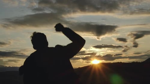 Young Guy Winning Moves Shadow Silhouette Back Shot with Mountain Sunset Skyline