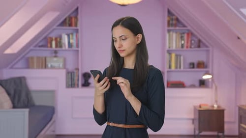Indian girl scrolling through phone