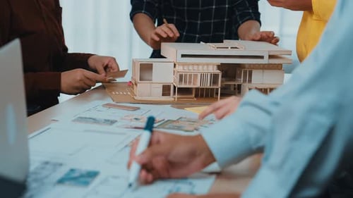 Architects Collaborate on Building Model and Blueprints