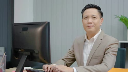 Portrait of Asian Businessman sit at office corporate business company working online on laptop