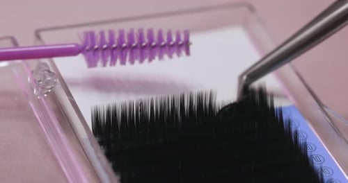 False Eyelashes Picked Up By Metal Tweezers