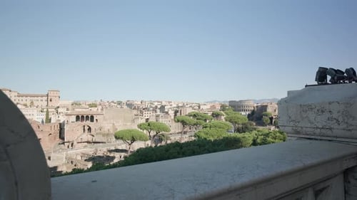 Woman In Historical Building Balcony Viewing The Architectural City Of Rome, Italy. Zoom In
