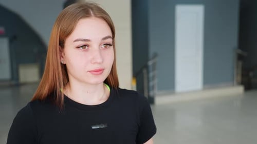 Focused Woman Exercising in Gym with Modern Background