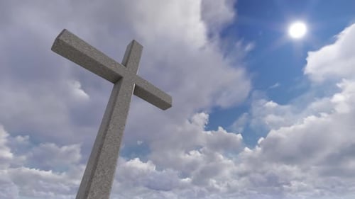 Religious Cross with Moving Clouds and Bright Sun