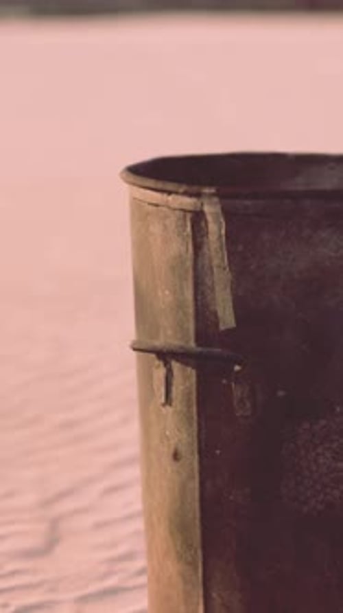 Gray Metal Garbage Bin or Trash Can on the Beach