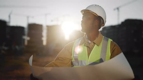 Portrait of Professional Engineer Examining Paper Drawing Audit and Inspection Black Builder with