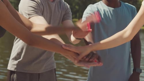 Diverse Athletes Join Hands in Unity Gesture