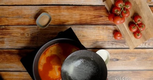 Mixing Cream Sauce with Tomato Sauce in Pan