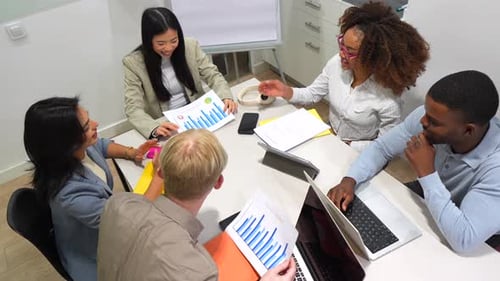 Team Meeting in Office Analyzing Charts and Data