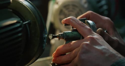 Hands Grinding Metal with Machine