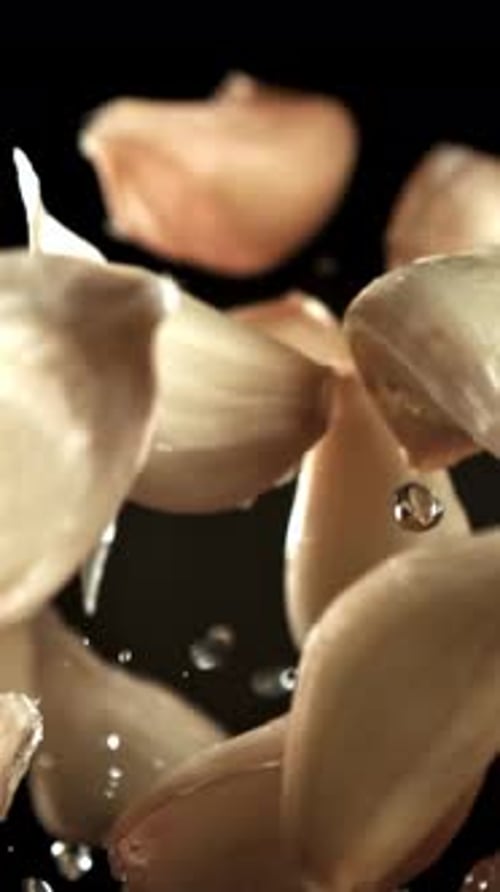 Garlic Flies Up with Drops of Water Filmed on a Highspeed Camera at 1000 Fps