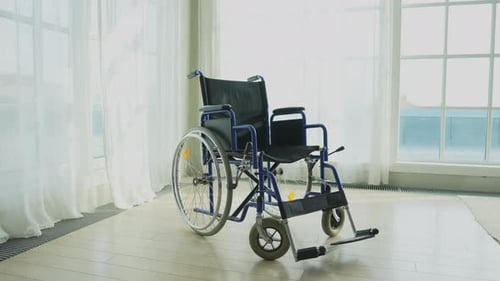 Empty Wheelchair Waiting for Patient Services in Living Room Retirement Home Hospital Chair for