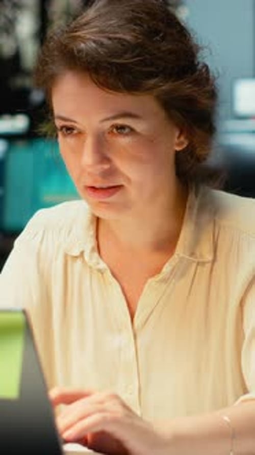 Focused woman works on her laptop in the office