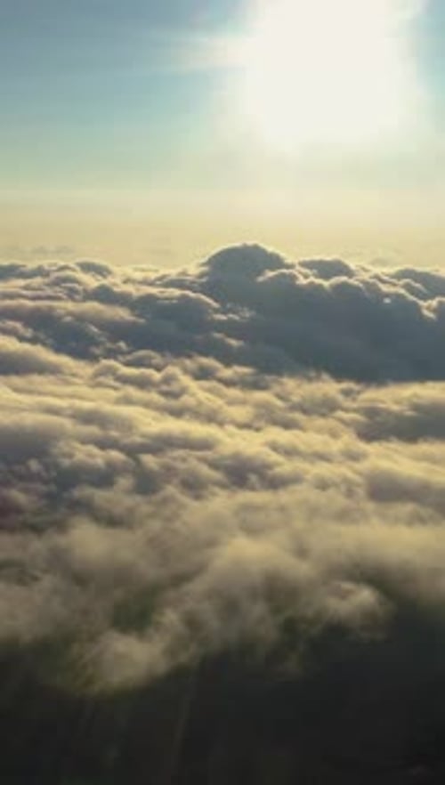 Aerial View of Thick Clouds Against Bright Sun