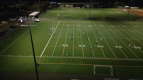 Aerial View Women Soccer Players Playing Soccer at the Stadium at Night