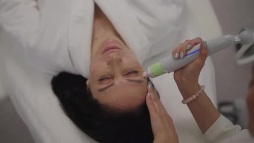 Woman Receiving Facial Treatment in a Spa