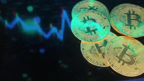 Bitcoin Cryptocurrency Coins with Stock Market Graph Background