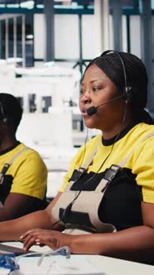Workers Operate Computer System at Manufacturing Plant