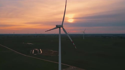 Wind Turbines Turning at Sunset in Rural Landscape