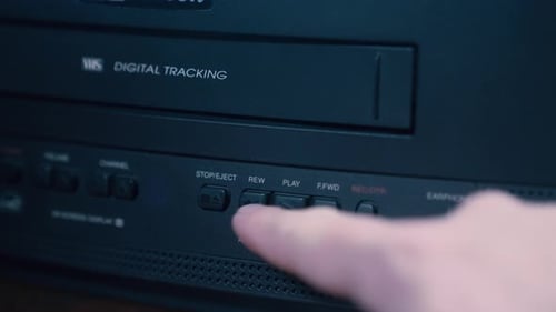 Close Up of Finger Rewinding VCR Machine