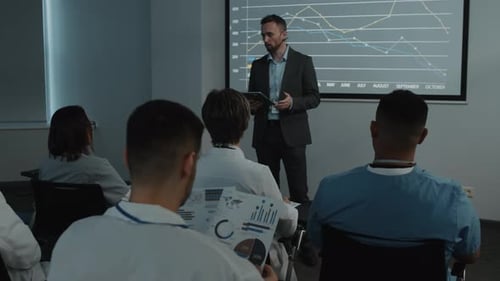 Medical Professionals Attending Business Presentation in Conference Room