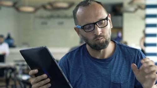 Young Man Using Modern Laptop During Meal in Cafe 30s