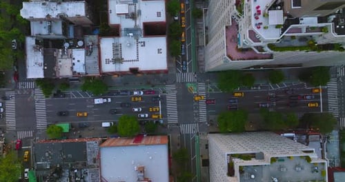 Private cars and yellow taxis ride by the roads of New York.