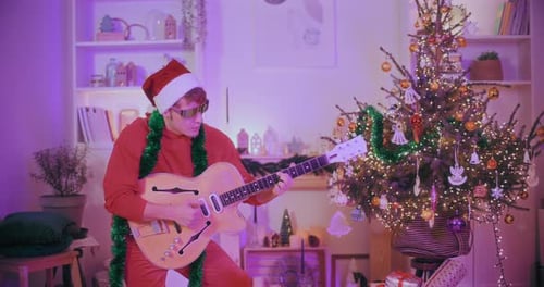 Man Plays Guitar at Christmas