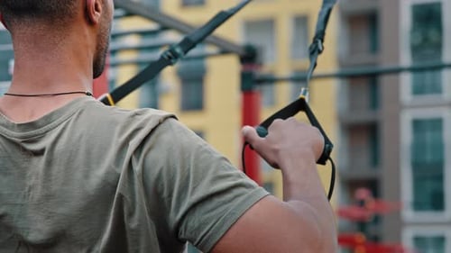 Muscular Man Working Out Using Resistance Bands