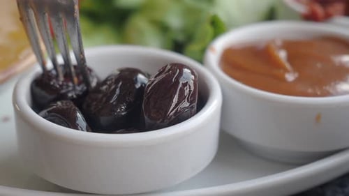 Delicious Breakfast Plate with Olives and Sauce