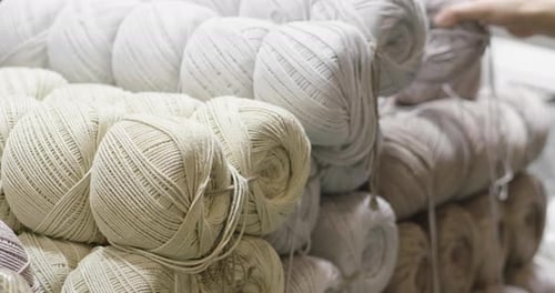Close up of a hand touching raw, warm and soft wool. Concept of: tenderness, softness, warm, cloth