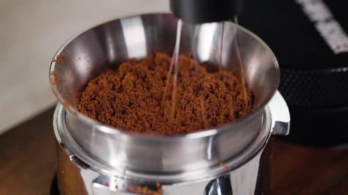 Ground Coffee Beans Being Stirred with Whisk