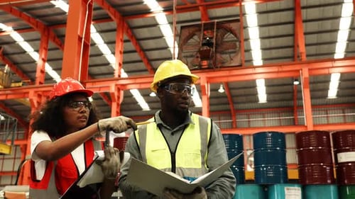 Factory Workers Consulting With Hard Hats