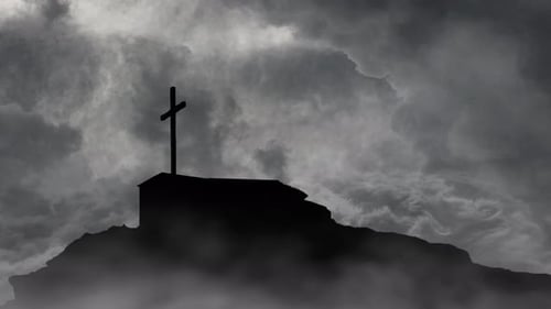 grave with cross on top of mountain silhouette