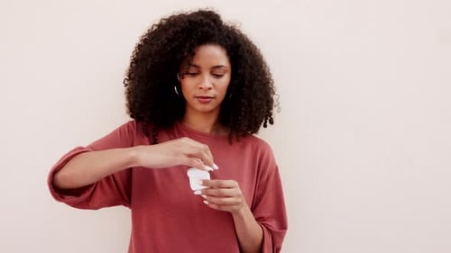 Woman Inserts and Adjusts Wireless Earbud