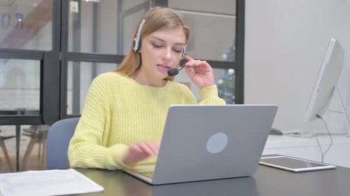 Female Call Center Employee with Headset Talking During Video Chat