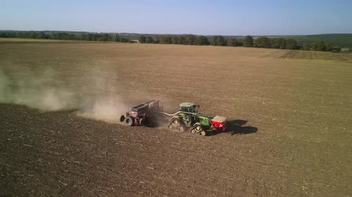 Tractor on the field seeding wheat